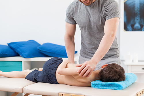 Village Family Clinic - Kid Getting Spinal Adjustment