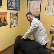 Dr. Hugo Torres performing spinal adjustment in Ironbound district of Newark NJ