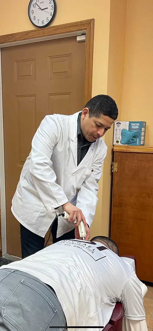 Dr. Hugo Torres using Impulse Adjusting Instrument in Ironbound district of Newark NJ