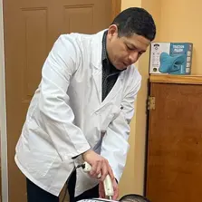 Dr. Hugo Torres using Impulse Adjusting Instrument in Ironbound district of Newark NJ